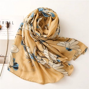 Detail of floral print scarf in ginger yellow with soft artistic texture and pattern