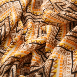 Detailed view of bohemian geometric waves and ethnic floral patterns on a cotton linen scarf