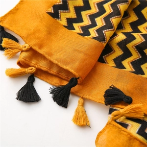 Close-up of mustard yellow and black chevron cotton linen scarf with fringe edges