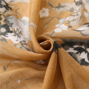 Macro detail of ginger floral shawl fabric showing soft cotton linen texture and pattern