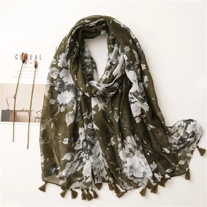 Green floral print shawl with fringe tassels and white flower patterns on lightweight fabric