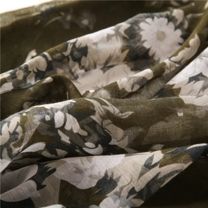 Close-up of lightweight floral fabric showing delicate daisy print and weave texture