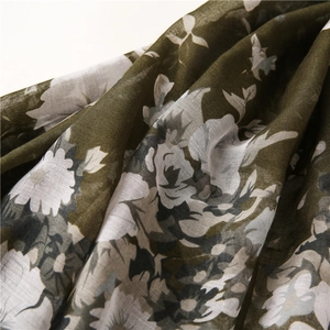 Detailed view of olive green floral scarf showing woven cotton-linen fabric texture