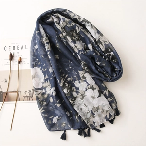 Detail of navy blue floral long scarf with elegant tassels and lightweight fabric texture