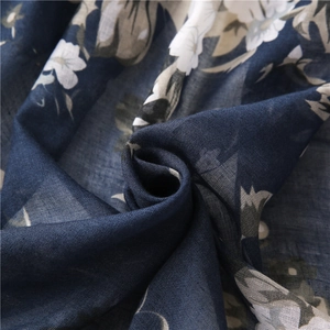 Detailed view of navy blue floral shawl showing soft fabric texture and elegant print