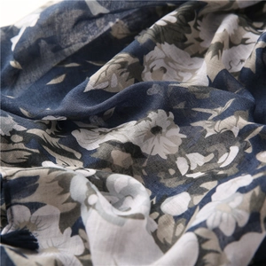 Detail shot of navy and white floral pattern showing breathable cotton texture on shawl