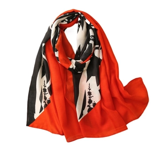 Women's orange scarf with artistic black and white floral prints on white background