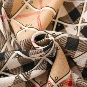 Macro view of geometric plaid scarf fabric showing soft texture and fine weaving details