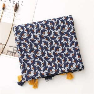 Detail of vintage blue floral scarf with elegant cotton-linen texture and tassels