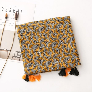 Detail of cotton-linen scarf with orange fan pattern and fringe tassels for women