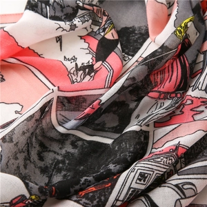 Detail of silk-texture scarf showing vintage comic print and coral red fabric folds