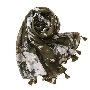 Elegant dark green floral scarf with long tassels and lightweight fabric on white background