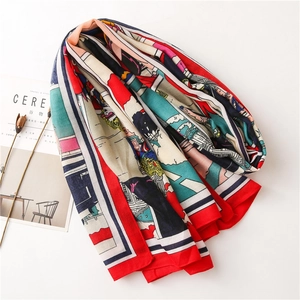 Detail of colorful illustrated scarf with bright red edges and soft silk texture