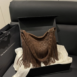 Brown leopard print suede hobo bag with long fringe details and gold buckle strap