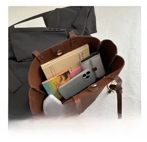 Interior view of large capacity brown leather tote bag showing spacious storage for books