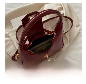 Top view of red glossy patent leather dumpling bag showing spacious interior storage