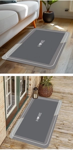 Detail of grey diatomite mat with HOME pattern on wooden floor and terrace indoor outdoor