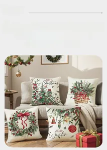 Detail of four Christmas pillow covers with festive wreaths and trees on a grey sofa