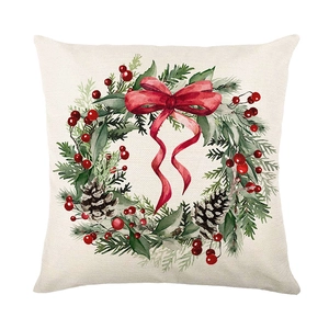 Square Christmas wreath pillow cover with watercolor holly and red bow on white background
