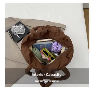 Internal capacity of brown quilted tote bag showing tablet, water bottle and essentials