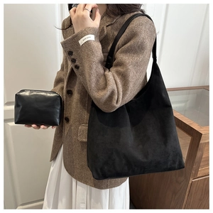 Detail of black suede hobo shoulder bag with a matching smooth leather zipper pouch