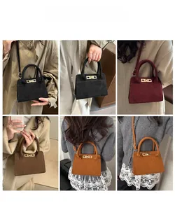 Macro shot of stylish vintage matte suede mini bags in black burgundy and brown tones