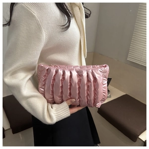 Detailed view of pink quilted puffy makeup bag with metallic finish and zipper