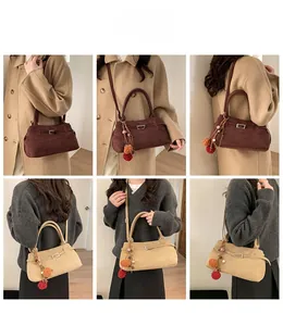 Close-up of suede tote bags in red-brown and beige with plush tassel and metal buckle