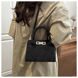Classic black frosted leather trapezoid handbag with gold lock and adjustable strap