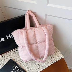 Pink quilted puffer tote bag with a soft padded design and wide shoulder strap