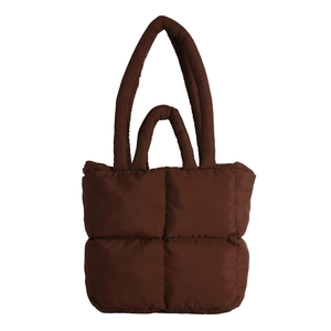 Brown quilted puffer tote bag with soft padded texture and dual handles for shoulder use