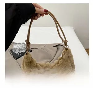 Detail of camel plush shoulder bag featuring vertical striped texture and knotted strap