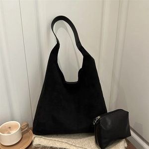 Minimalist black suede hobo shoulder bag set with matching small PU leather pouch on a table