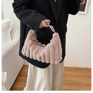 Detail of light purple faux fur shoulder bag with plush pleated texture and knotted handle