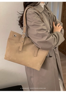 Detail of trendy tote bag with adjustable silver buckles and vintage metal eyelets
