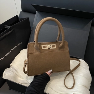 Vintage dark brown frosted leather handbag with gold clasp on premium gift packaging