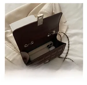 Detailed view of spacious interior storage for dark brown quilted leather crossbody bag