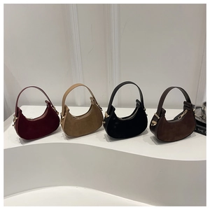 Collection of minimalist crescent moon shoulder bags in suede and assorted colors