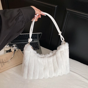 White faux fur shoulder bag with plush striped design and leather strap for winter