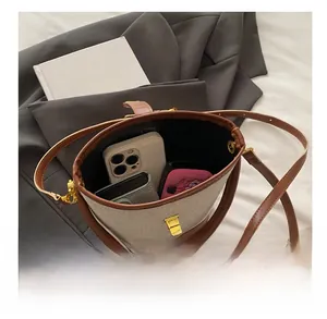 Detailed top view of a canvas bucket bag interior showing phone and wallet storage space