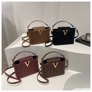 Group display of leopard print tote bags in black, camel, burgundy, and coffee tones
