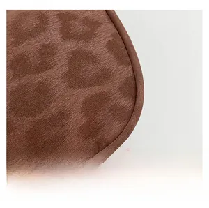 Detail of brown leopard print faux fur texture and precise stitching on the shoulder bag