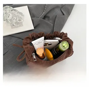 Top view of brown pleated handbag interior showing spacious capacity for daily essentials