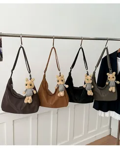 Detail view of large hobo tote bags in four retro colors with cute plush rabbit charms
