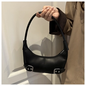 Detail of black leather crescent bag with silver buckle and matte vintage texture