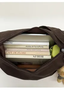 Top-down view of spacious tote interior filled with laptop, books, and accessories