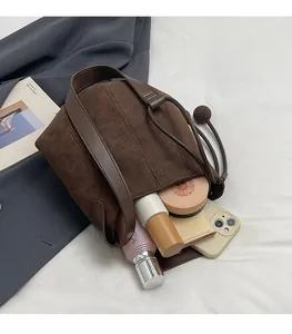 Interior view of brown frosted suede bucket bag showing spacious storage for daily essentials