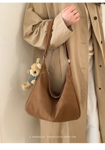 Brown retro suede tote bag detail with adjustable strap and cute bear pendant charm