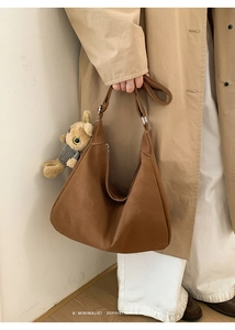 Retro brown suede tote bag details with cute plush bunny charm on shoulder strap