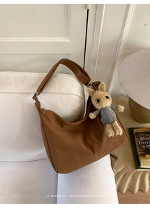 Brown retro tote bag with suede texture featuring a cute plush bunny charm detail